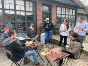 A group of people sitting in a circle having a discussion.